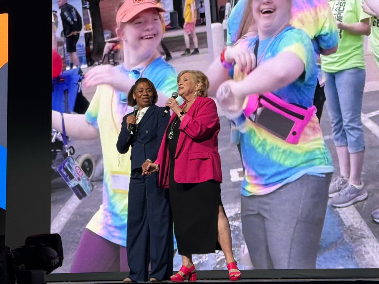 Wendee singing onstage with a co-host at a large event