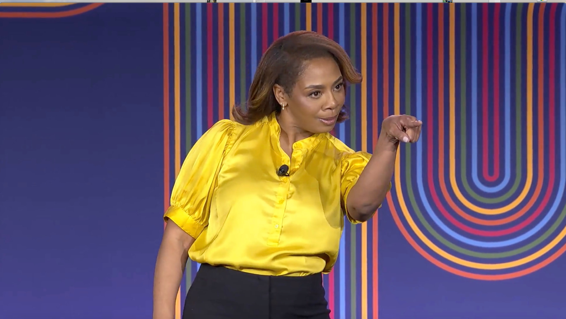 Wendee on stage addressing a large audience